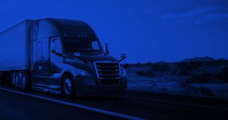 Long-haul semi truck on a rural western highway.