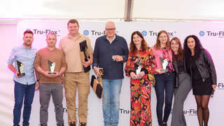 A group of people celebrating 10 years of operation at Nelson Global's plant in Poland.