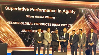 A group of people accepting an award from Ashok Leyland.